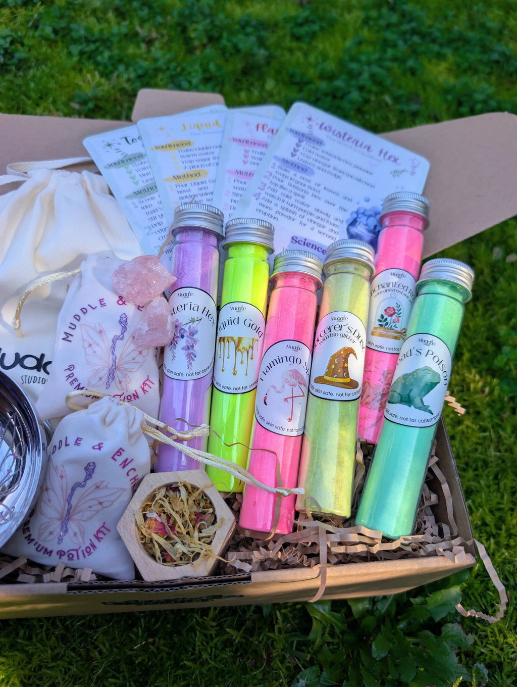 Muddle & Enchant kit with colourful test tubes, crystals and story cards in the box 
