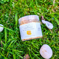 Gold Glint Petal Flutters jar on grass beside white stones