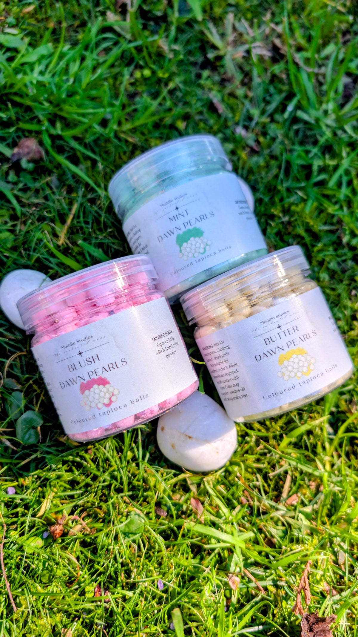 Mint, Blush and Butter Dawn Pearls jars grouped together on grass 